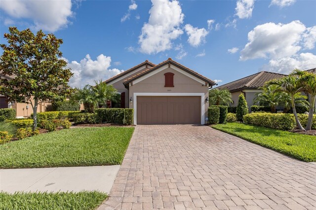 11611 Callisia Dr, Odessa, FL 33556 - single story home with decorative driveway, an attached garage, a front yard, and stucco siding