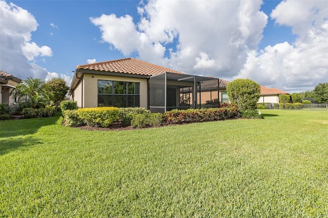 11611 Callisia Dr, Odessa, FL 33556 - back of house with a tiled roof, a yard, stucco siding, and a lanai