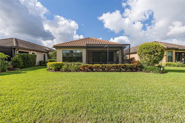 11611 Callisia Dr, Odessa, FL 33556 - back of house featuring a tile roof, stucco siding, a lawn, and ceiling fan