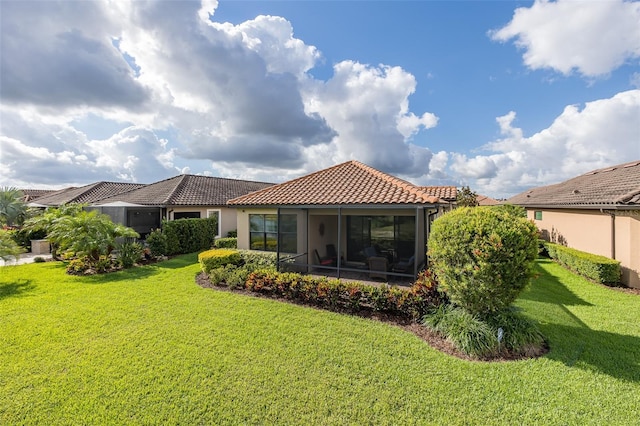 11611 Callisia Dr, Odessa, FL 33556 - back of house featuring a tile roof, a yard, stucco siding, and a sunroom