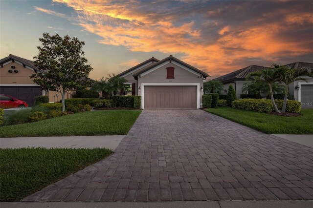 11611 Callisia Dr, Odessa, FL 33556 - single story home with decorative driveway, an attached garage, a yard, and stucco siding