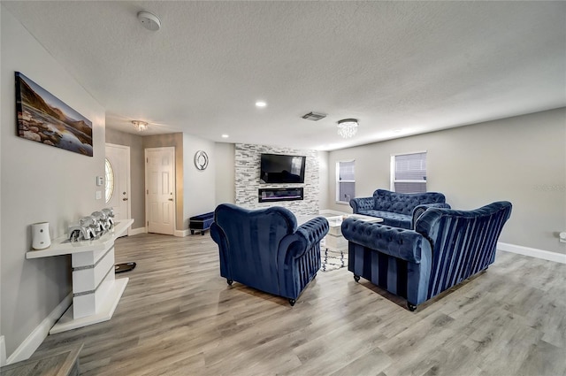 6222 Cherry Blossom Trl, Gibsonton, FL 33534 - living room with a textured ceiling, baseboards, light wood-style flooring, a fireplace, and recessed lighting