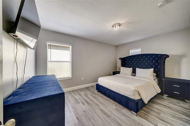 6222 Cherry Blossom Trl, Gibsonton, FL 33534 - bedroom with wood finished floors, baseboards, and a textured ceiling