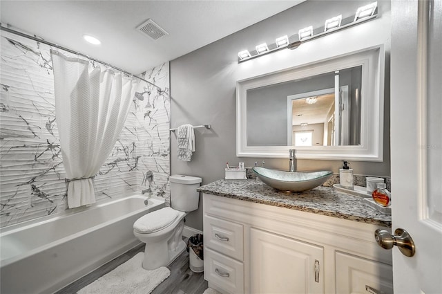 6222 Cherry Blossom Trl, Gibsonton, FL 33534 - full bath featuring vanity, shower / bath combination with curtain, toilet, and wood finished floors