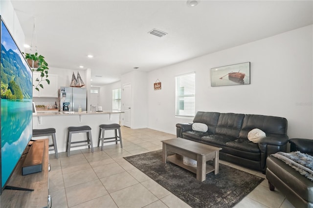 living room featuring light tile patterned floors and recessed lighting