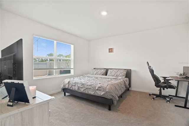 bedroom with carpet, baseboards, and an office area