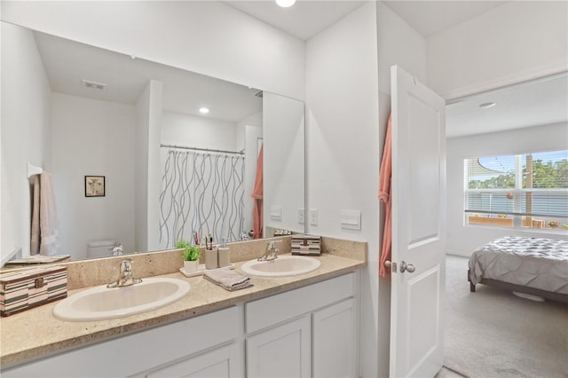 full bath with toilet and double vanity