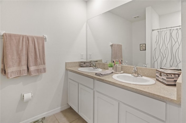 bathroom with double vanity and tile patterned flooring