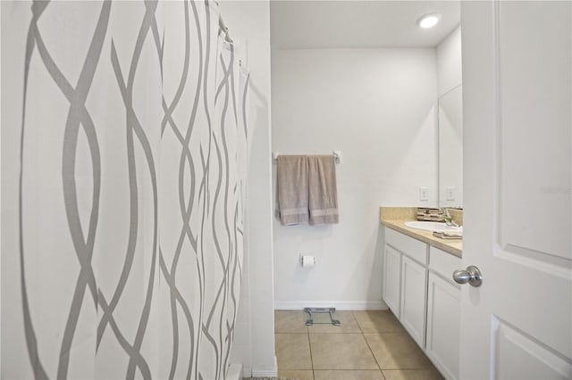 full bathroom featuring vanity, tile patterned flooring, baseboards, and curtained shower