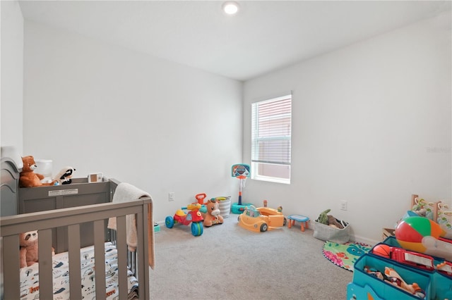 bedroom with carpet and a nursery area