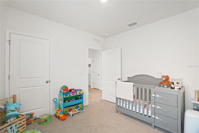 bedroom featuring carpet flooring and a nursery area
