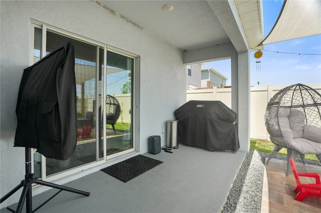 view of patio with a grill and fence