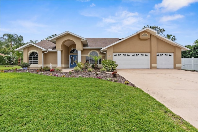 view of front of house with stucco siding, a garage, and concrete driveway