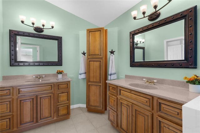 bathroom with vaulted ceiling, a chandelier, two vanities, tile patterned flooring, and baseboards