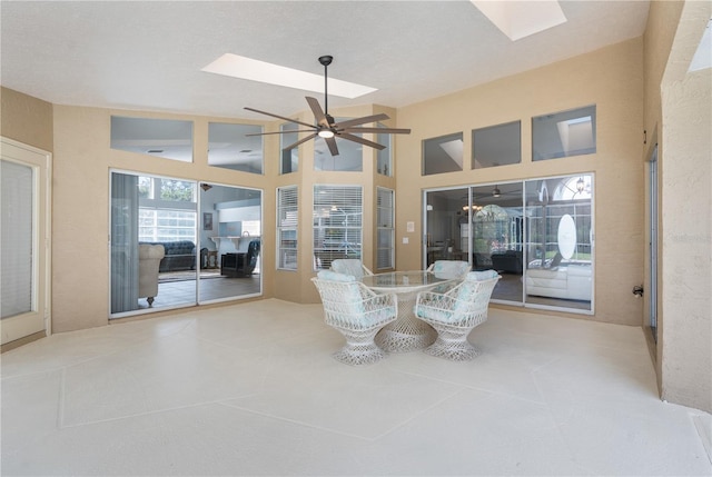 sunroom featuring a skylight and lofted ceiling