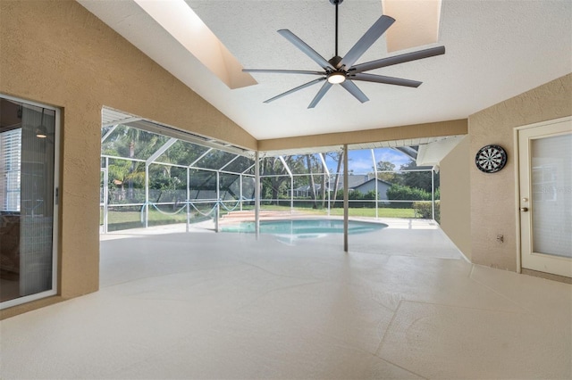 outdoor pool with a patio area, ceiling fan, and glass enclosure