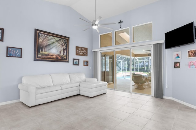 living room featuring high vaulted ceiling, a ceiling fan, light tile patterned floors, and baseboards