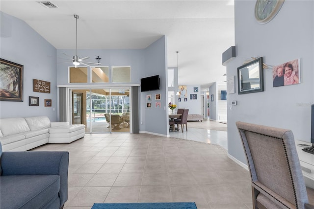 living room with high vaulted ceiling, ceiling fan, light tile patterned floors, and baseboards