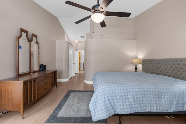 bedroom featuring high vaulted ceiling, light wood finished floors, baseboards, and a ceiling fan
