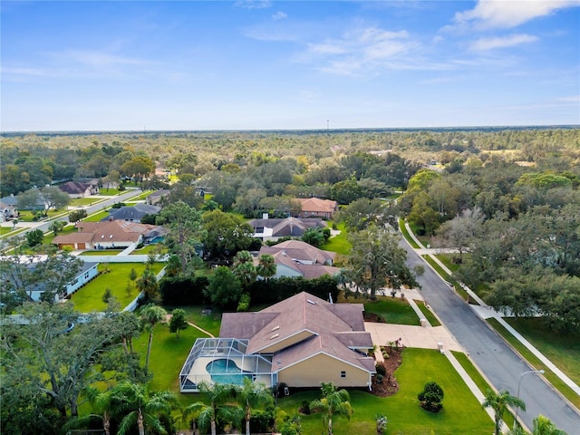 aerial view of residential area with a heavily wooded area