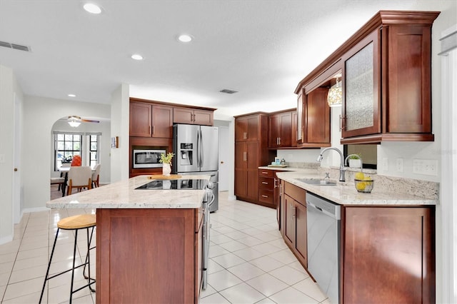 6454 Summerfield Loop, New Port Richey, FL 34655 - kitchen featuring stainless steel appliances, a sink, a kitchen breakfast bar, light tile patterned floors, and recessed lighting