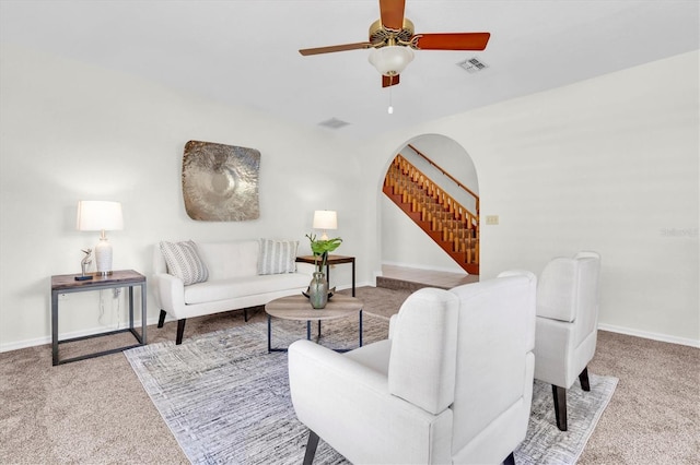 6454 Summerfield Loop, New Port Richey, FL 34655 - carpeted living area featuring stairs, arched walkways, ceiling fan, and baseboards