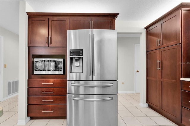 6454 Summerfield Loop, New Port Richey, FL 34655 - kitchen featuring appliances with stainless steel finishes, light tile patterned floors, and baseboards