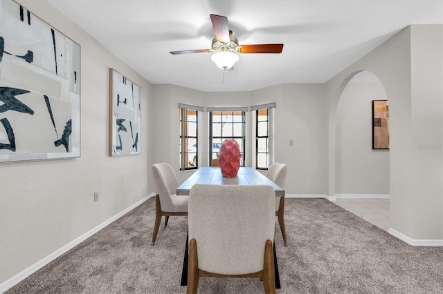6454 Summerfield Loop, New Port Richey, FL 34655 - dining room with carpet, arched walkways, ceiling fan, and baseboards