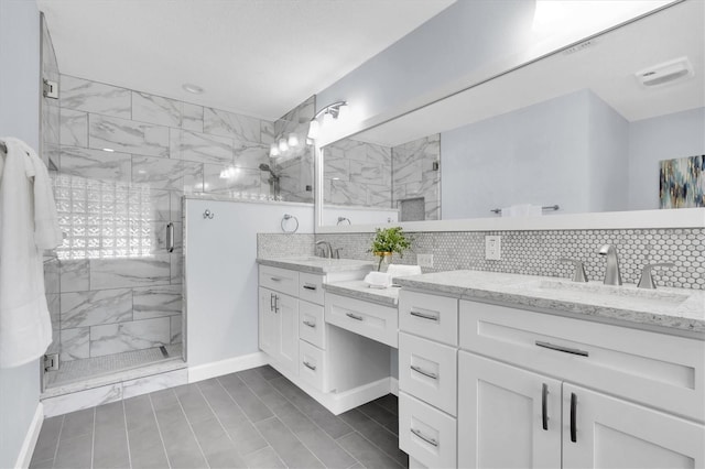 6454 Summerfield Loop, New Port Richey, FL 34655 - bathroom featuring backsplash, a stall shower, and double vanity