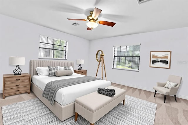 6454 Summerfield Loop, New Port Richey, FL 34655 - bedroom with light colored carpet, multiple windows, baseboards, and a ceiling fan
