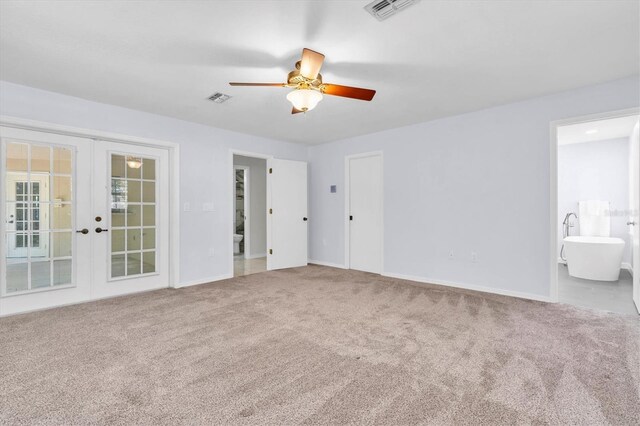 6454 Summerfield Loop, New Port Richey, FL 34655 - unfurnished bedroom featuring french doors, carpet floors, baseboards, and connected bathroom