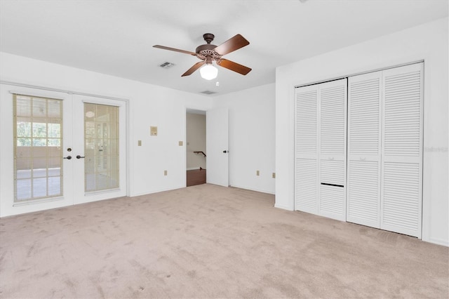 6454 Summerfield Loop, New Port Richey, FL 34655 - unfurnished bedroom featuring french doors, carpet, and ceiling fan