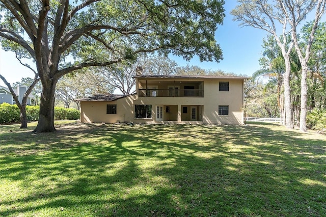 6454 Summerfield Loop, New Port Richey, FL 34655 - back of property with a balcony, stucco siding, and a chimney