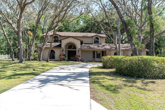 6454 Summerfield Loop, New Port Richey, FL 34655 - view of front of property with stucco siding, driveway, and a front lawn