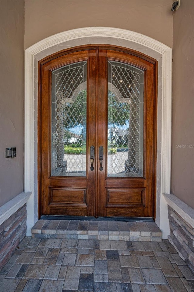 9933 Milano Dr, Trinity, FL 34655 - property entrance with french doors and stucco siding