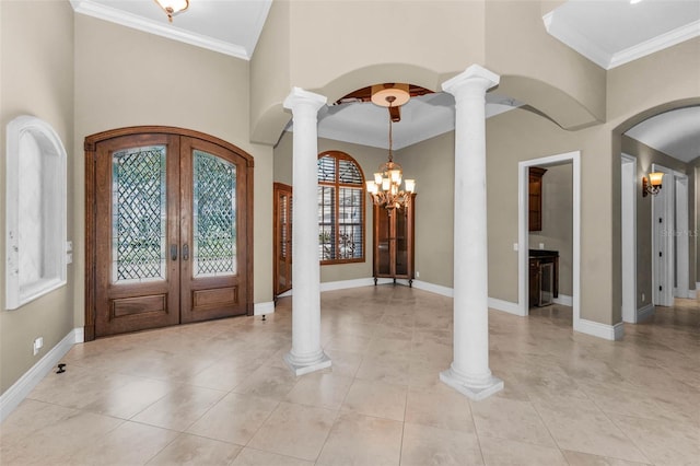 9933 Milano Dr, Trinity, FL 34655 - foyer entrance with french doors, arched walkways, baseboards, a chandelier, and decorative columns