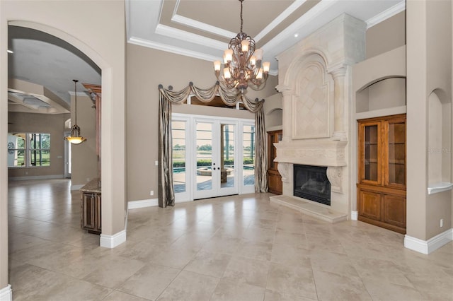 9933 Milano Dr, Trinity, FL 34655 - unfurnished living room with arched walkways, crown molding, light tile patterned floors, french doors, and baseboards
