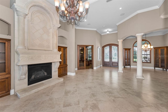 9933 Milano Dr, Trinity, FL 34655 - entrance foyer with a chandelier, french doors, ornate columns, a fireplace, and ornamental molding