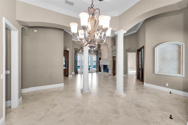 9933 Milano Dr, Trinity, FL 34655 - unfurnished dining area featuring arched walkways, a chandelier, baseboards, light tile patterned floors, and decorative columns