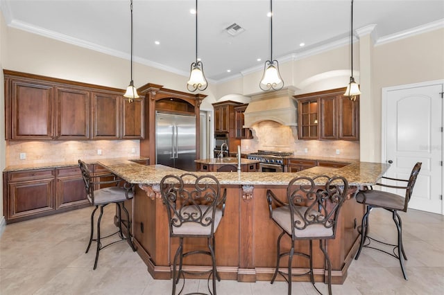 9933 Milano Dr, Trinity, FL 34655 - kitchen featuring high end appliances, premium range hood, light tile patterned flooring, a spacious island, and crown molding