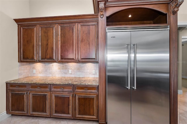 9933 Milano Dr, Trinity, FL 34655 - kitchen featuring stainless steel built in refrigerator, light stone counters, decorative backsplash, and light tile patterned flooring