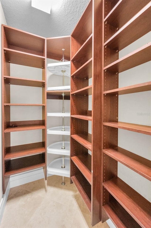 9933 Milano Dr, Trinity, FL 34655 - spacious closet featuring tile patterned floors