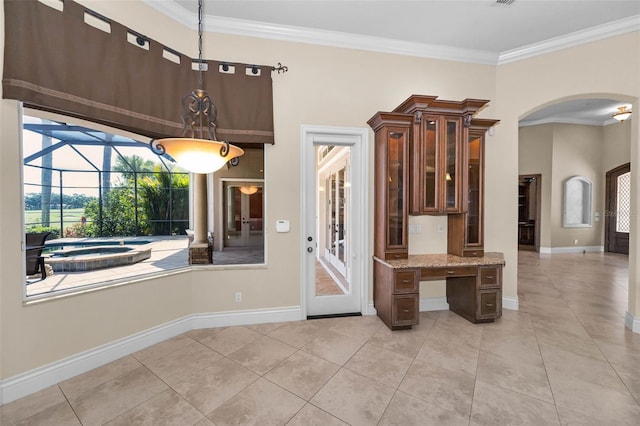 9933 Milano Dr, Trinity, FL 34655 - kitchen featuring arched walkways, crown molding, light tile patterned floors, a sunroom, and light stone counters