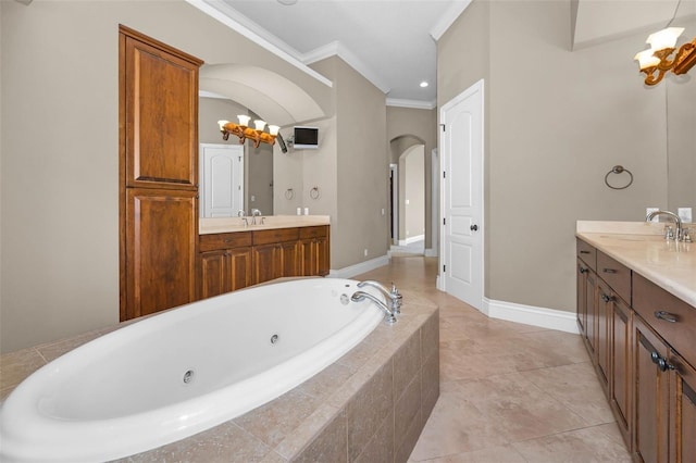 9933 Milano Dr, Trinity, FL 34655 - full bathroom with crown molding, two vanities, a whirlpool tub, and baseboards