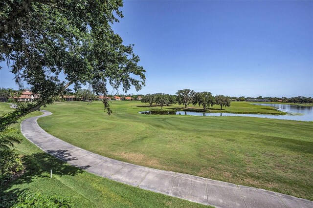 9933 Milano Dr, Trinity, FL 34655 - view of property's community with a water view, view of golf course, and a lawn