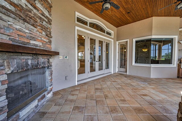 9933 Milano Dr, Trinity, FL 34655 - view of patio / terrace with french doors, a ceiling fan, and an outdoor stone fireplace