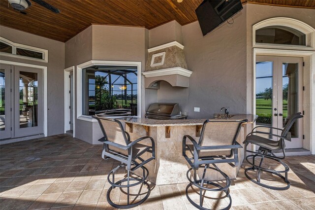 9933 Milano Dr, Trinity, FL 34655 - view of patio / terrace with french doors, a grill, and area for grilling