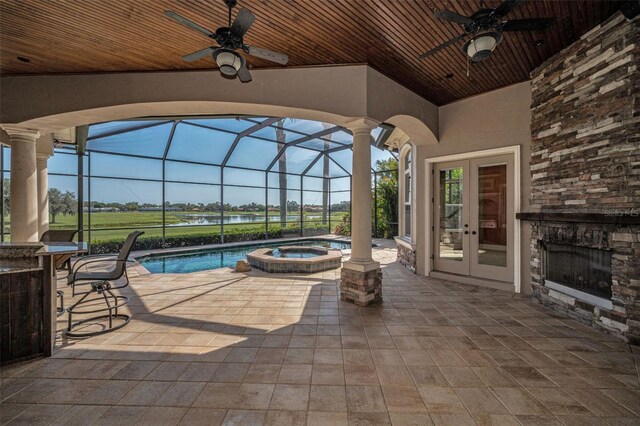 9933 Milano Dr, Trinity, FL 34655 - view of patio / terrace featuring a ceiling fan, a water view, a pool with connected hot tub, french doors, and a lanai