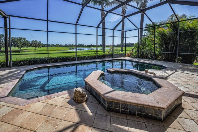 9933 Milano Dr, Trinity, FL 34655 - view of pool with glass enclosure, a patio, and a pool with connected hot tub