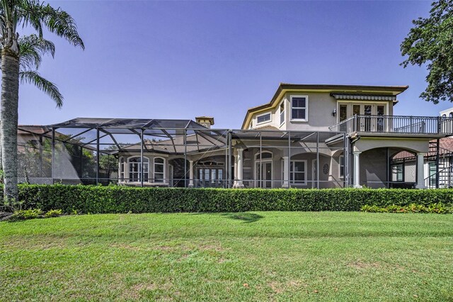 9933 Milano Dr, Trinity, FL 34655 - rear view of property featuring stucco siding, a yard, and glass enclosure
